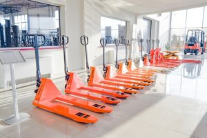 Orange forklifts placed in a row