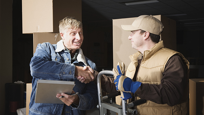 Two long distance movers NYC shaking hands