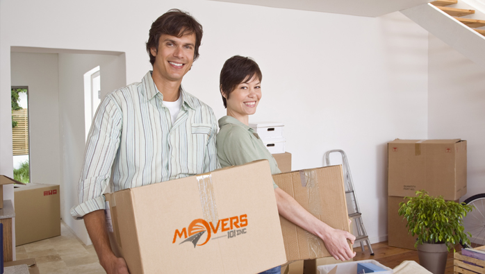 Couple carrying moving boxes