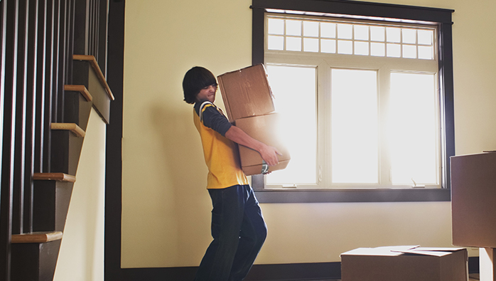 Boy carrying boxes