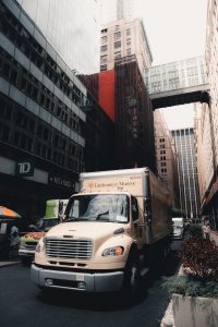 beige truck for moving to Gowanus parked on the side of a street