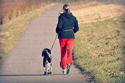 -a woman running with a dog