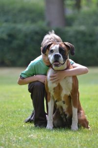 Boy hugging a dog