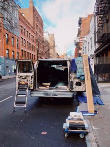 van with open doors and moving equipment