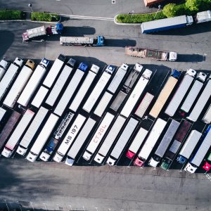 trailer trucks lined up in a parking lot