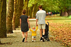 Family walking in a park after moving interstate with kids.