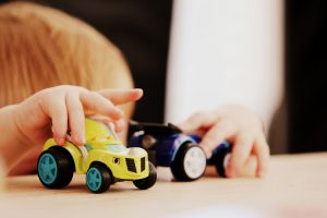 Child playing with toy cars.