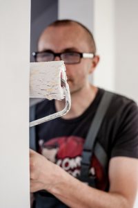 man painting apartment to cheap NYC apartments for rent