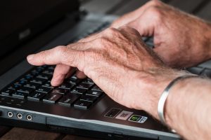 a boos typing his email in order to prepare employees for an office move