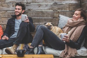 two people and a pug