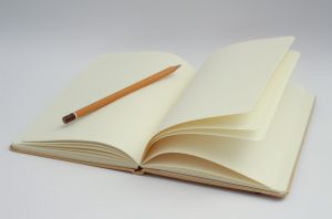 notebook with pencil and packing tips for businesses