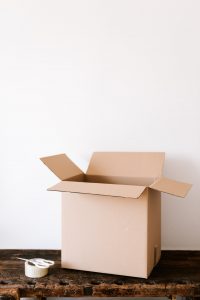 packing boxes on a table are a way to save money on a long distance relocation