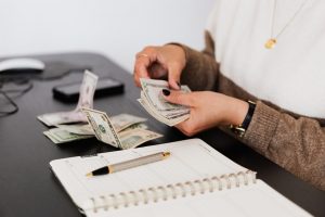 person counting how much to save for a long distance relocation